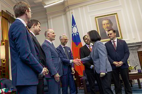 In this photo released by the Taiwan Presidential Office, Taiwan's President Tsai Ing-wen, second right, shakes hands with members of United States Congress