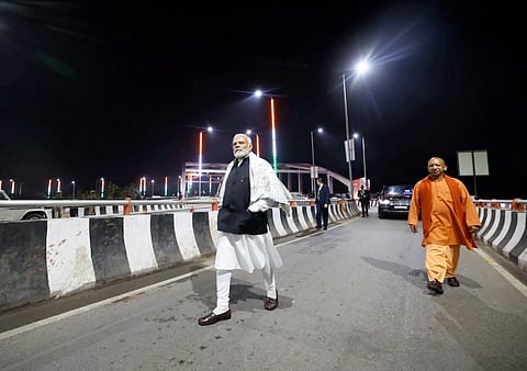 Prime Minister Narendra Modi with Uttar Pradesh Chief Minister Yogi Adityanath inspects the Shivpur-Phulwaria-Lahartara Marg upon his arrival in Varanasi, late Thursday, Feb. 22, 2024.