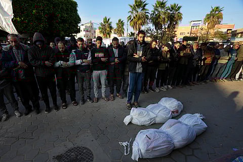 Palestinians pray for the relatives killed in the Israeli bombing in the Gaza Strip at Al Aqsa Hospital in Deir al Balah, Gaza Strip, on Saturday, Feb. 17, 2024
