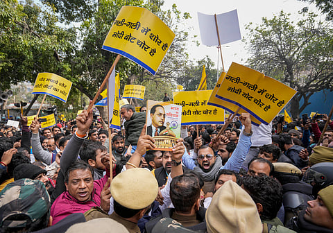 Police personnel stop AAP supporters during a protest in New Delhi on Friday, February 2, 2024.