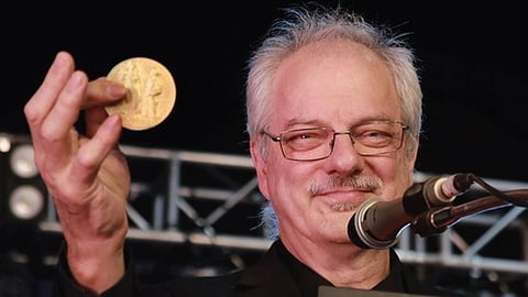 Nobel laureate Morten P. Meldal showing the Nobel prize to the audience during a public talk at the Global Science Festival Kerala (GSFK) at Life Sciences Park Thonnakkal on Wednesday.