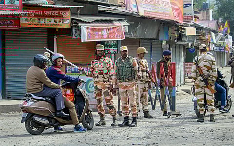 Indo-Tibetan Border Police (ITBP) personnel stand guard on a road during a curfew in the Banbhoolpura area, following incidents of violence after the demolition of an 'illegally built' madrasa in Haldwani on Monday, February 12, 2024.