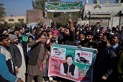 Supporters of imprisoned Pakistan's Former Prime Minister Imran Khan's party block a road as a protest against the delaying result of parliamentary election by Pakistan Election Commission, in Lahore, Pakistan, Friday, Feb. 9, 20204.