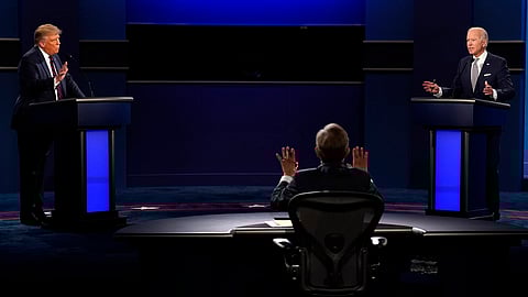 Chris Wallace, of Fox News, center, moderates as President Donald Trump, left, and Democratic candidate former Vice President Joe Biden, speak during the a presidential debate, Sept. 29, 2020, in Cleveland.