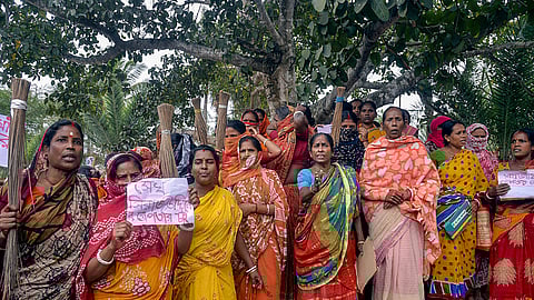 Women holding posters stage a protest demanding the arrest of local TMC leaders over Sandeshkhali incident allegations, in North 24 Parganas district