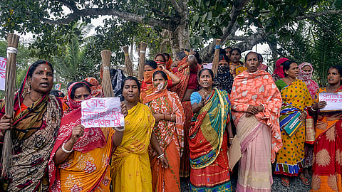 Women holding posters stage a protest over the Sandeshkhali incident allegations in North 24 Parganas district.