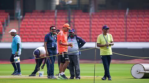 India's cricket coach Rahul Dravid checks the pitch during practice session ahead of their first cricket test match against England in Hyderabad, India, Wednesday, Jan. 24, 2024.