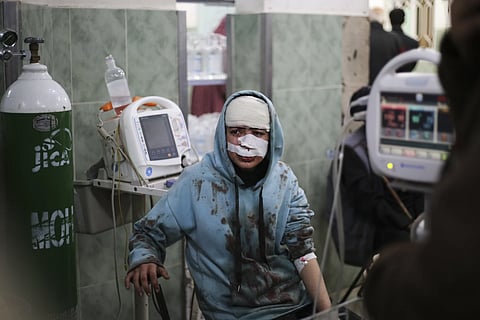 A Palestinian wounded in Israeli bombardment sits in a hospital in Rafah, Gaza Strip, Saturday, Feb 10, 2024.