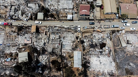Locals clean the rubble of burnt-out houses after forest fires reached their neighborhood in Vina del Mar, Chile, Sunday, Feb. 4, 2024.