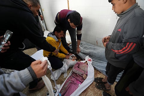 Palestinians mourn over their relatives killed in the Israeli bombardments of the Gaza Strip at Al Aqsa Hospital in Deir al Balah, Gaza Strip, on Sunday, Feb. 18, 2024.