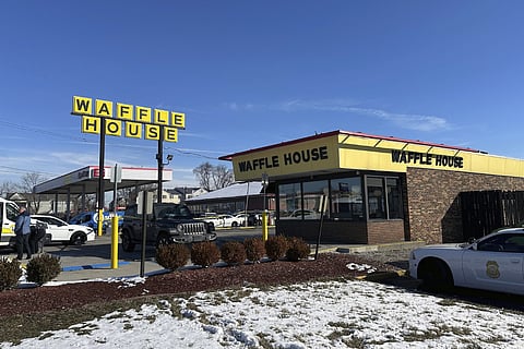 Police cars are shown near a Waffle House in Indianapolis Monday, Feb. 19, 2024, where at least one person was killed and several injured.