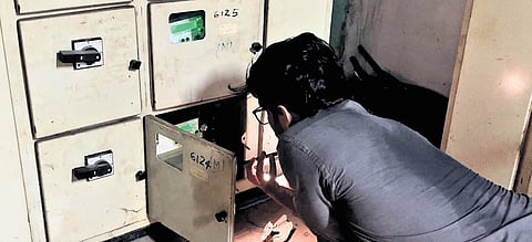 A KSEB official removes the fuse of one of the offices at the collectorate