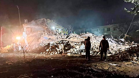 Firefighters examine the site of Russia's missile attack that hit an apartment building in Kharkiv Region, Ukraine, Thursday, Feb.15, 2024.