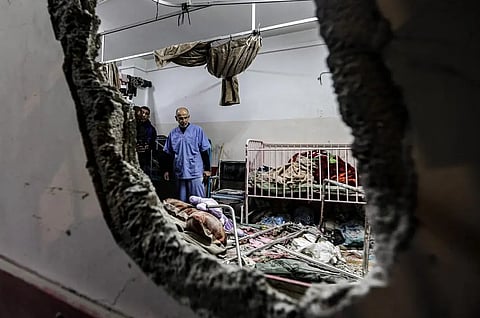 People inspect the damage in a room following Israeli bombardment at Nasser hospital in Khan Yunis in the southern Gaza Strip on December 17, 2023, amid the ongoing Israel-Hamas war.