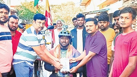 Muttu Selvan, a fan of late Puneet Rajkumar, being felicitated for scaling India, China, Vietnam and other countries on his bicycle in an attempt to create a record
