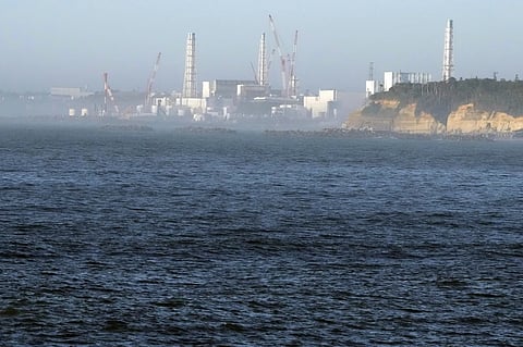 FILE - The Fukushima Daiichi nuclear power plant, damaged by a massive March 11, 2011, earthquake and tsunami, is seen from the nearby Ukedo fishing port in Namie town, northeastern Japan, on Aug. 24, 2023.