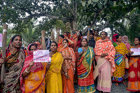 Women holding posters stage a protest demanding the arrest of local TMC leaders over the Sandeskhali allegations in North 24 Parganas district