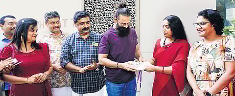 Actor Jolly Chirayath inaugurating the delegate pass distribution of WIFFK
by giving a pass to actor Jayasurya on Friday.