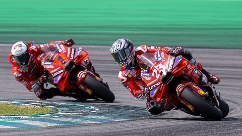 Ducati Italian rider Francesco Bagnaia (L) and Ducati Lenovo Team's Italian rider Enea Bastianini (R) take a corner during the second day of the pre-season MotoGP test at the Sepang International Circuit in Sepang on February 7, 2024.