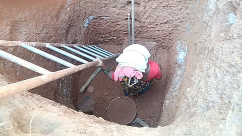 Gowri Naik digging a well