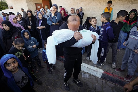 A Palestinian morns a relative killed in the Israeli bombing of the Gaza Strip in Deir al Balah, Gaza Strip, on Sunday, Feb. 11, 2024.
