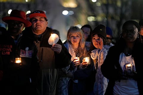 People attend a candlelight vigil for victims of a shooting at a Kansas City Chiefs Super Bowl victory rally Thursday, Feb. 15, 2024 in Kansas City