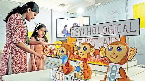 A child checks out an exhibit on mental health, during the Mental Health Santhe 2.0, at the NIMHANS Convention Centre in Bengaluru on Tuesday