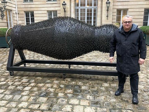 Mikhail Reva with one of his art pieces.