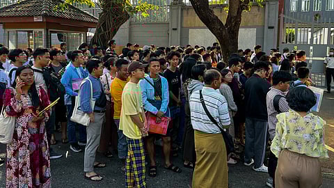 People gather outside the embassy of Thailand to get visas in Yangon on February 16, 2024, after Myanmar's military government said it would impose military service.