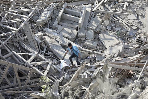 A Palestinian boy walk through the destruction left by the Israeli air and ground offensive on the Gaza Strip in Gaza City, Saturday, Feb 10, 2024.