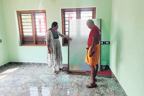 Sreenath and Sreelakshmi checking the damage to their new house.