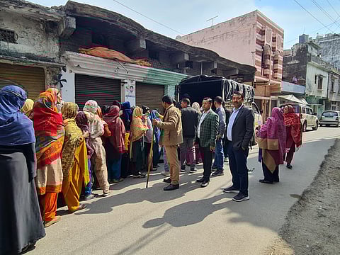 District administration officials distribute daily needs to the affected people in curfew-bound areas.