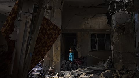 A Palestinian child looks at the damage to his family's house after an Israeli strike in Rafah, southern Gaza Strip, Thursday, Feb 8, 2024.