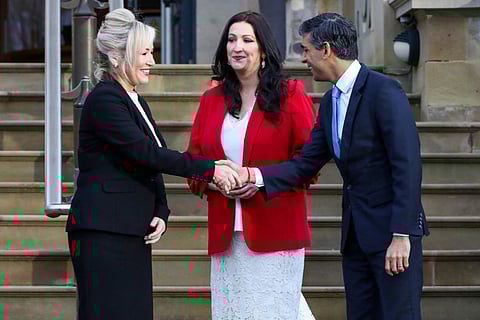 Britain's Prime Minister Rishi Sunak (R) shakes hands with newly appointed Northern Ireland's First Minster, Sinn Fein's Michelle O'Neill (R) next to newly appointed Northern Ireland's deputy First Minster, Democratic Unionist Party's Emma Little Pengelly (C) upon arrival at Stormont Castle, in Stormont, on February 5, 2024.