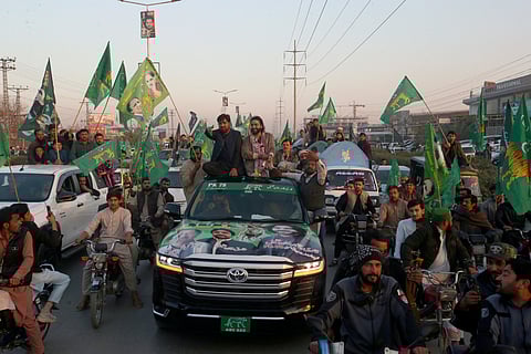 Qari Zahir Shah, centre right on the vehicle, a winning candidate from Pakistan's former prime minister Nawaz Sharif's party 'Pakistan Muslim League-N, leads a rally with his supporters.