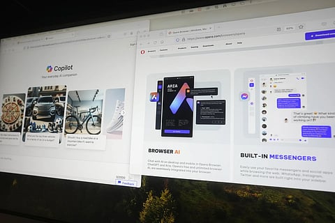 Copilot and Opera pages showing the incorporation of AI technology are displayed in London, Tuesday, February 13, 2024.