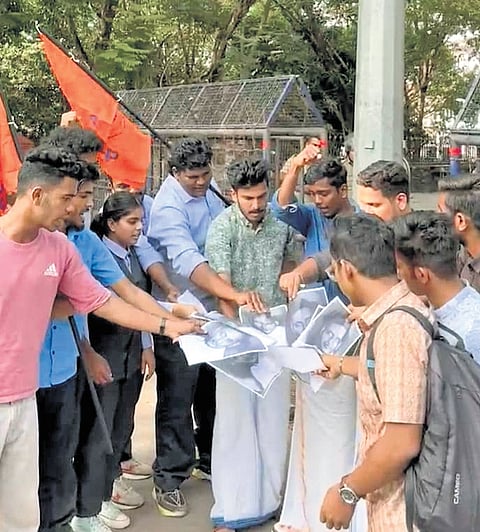 ABVP activists burning the photographs of Godse at the entrance of NIT in Kozhikode.