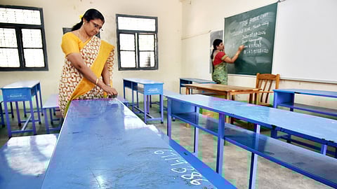 The staff deputed for board exams preparing the classrooms.
