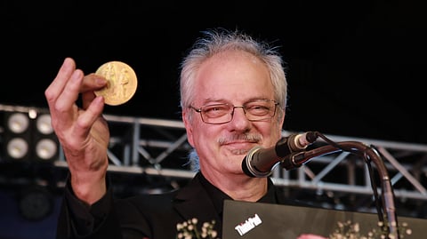 Nobel laureate Morten P. Meldal showing the Nobel prize to the audience during a public talk at the Global Science Festival Kerala (GSFK) at Life Sciences Park Thonnakkal on Wednesday.