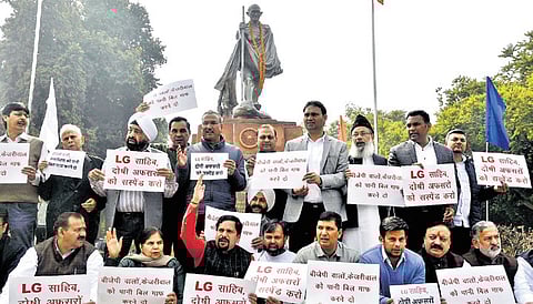 AAP MLAs raising slogans against L-G outside the House on Tuesday
