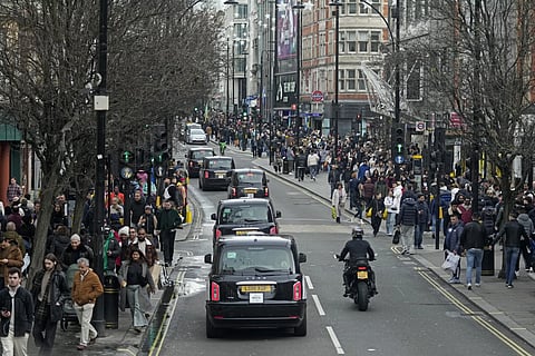 Shoppers walk along Oxford Street during the Boxing Day sales in London on Dec 26, 2023.