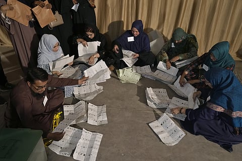 Members of polling staff count the votes after the polls closed for parliamentary elections, in Karachi, Pakistan, Thursday, Feb 8, 2024.