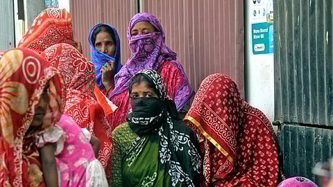 Local women wait to meet the National Commission for Women (NCW) representative at Sandeshkhali.