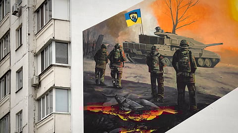 A mural depicts volunteer soldiers of the 3rd assault brigade to honour the memory of their fellow soldier Serhiy Mashovets on an apartment building wall in Kyiv, Ukraine, Thursday, Feb. 1, 2024.