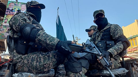 Paramilitary soldiers guard outside a polling station to ensure security during the country's parliamentary elections in Multan, Pakistan