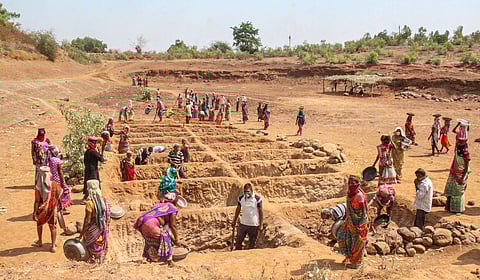 Labourers work at a construction site under the MGNREGA scheme in Navsari, Gujarat.
