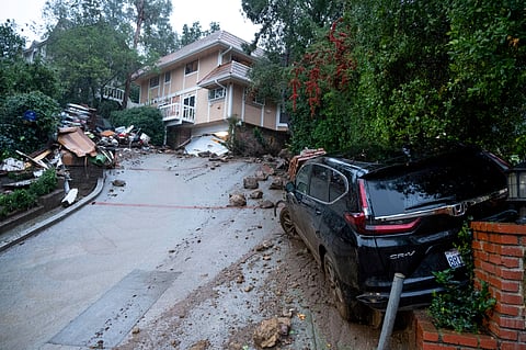 Storm damage from mud, rock and debris flows along Lockridge Road in Studio City, Calif., has caused major damage to vehicles and houses in the area.