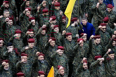 Hezbollah fighters raise their fists and shout slogans during the funeral of their senior commander Ali Dibs who was killed by an Israeli airstrike Wednesday night, in Nabatiyeh town, south Lebanon, Friday, Feb. 16, 2024. Image used for representation
