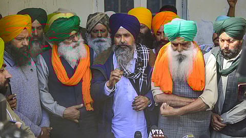 Farmer leader Swarn Singh Pandher (in blue turban) with Jagjit Singh Dallewal and others speaks to the media a day after clashes with security forces at Shambhu border during the farmers' 'Delhi Chalo' march, at the Government Rajindra Hospital in Patiala, Thursday, Feb. 22, 2024.