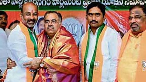 BJP MP Bandi Sanjay greets party’s state in-charge Tarun Chugh at a LS Pravas Yojana meeting in Karimnagar.